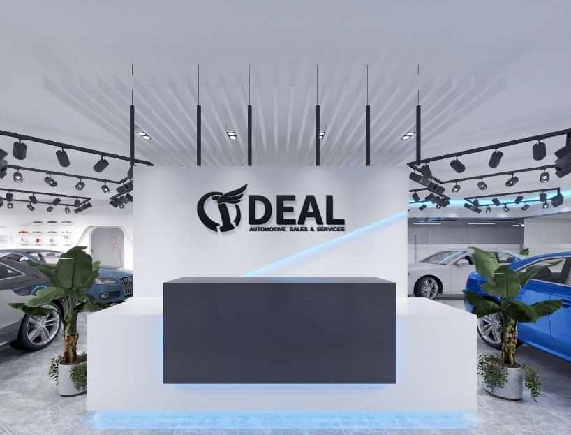 Interior of Ideal Auto Sales Staten Island car dealership showroom with cars displayed.