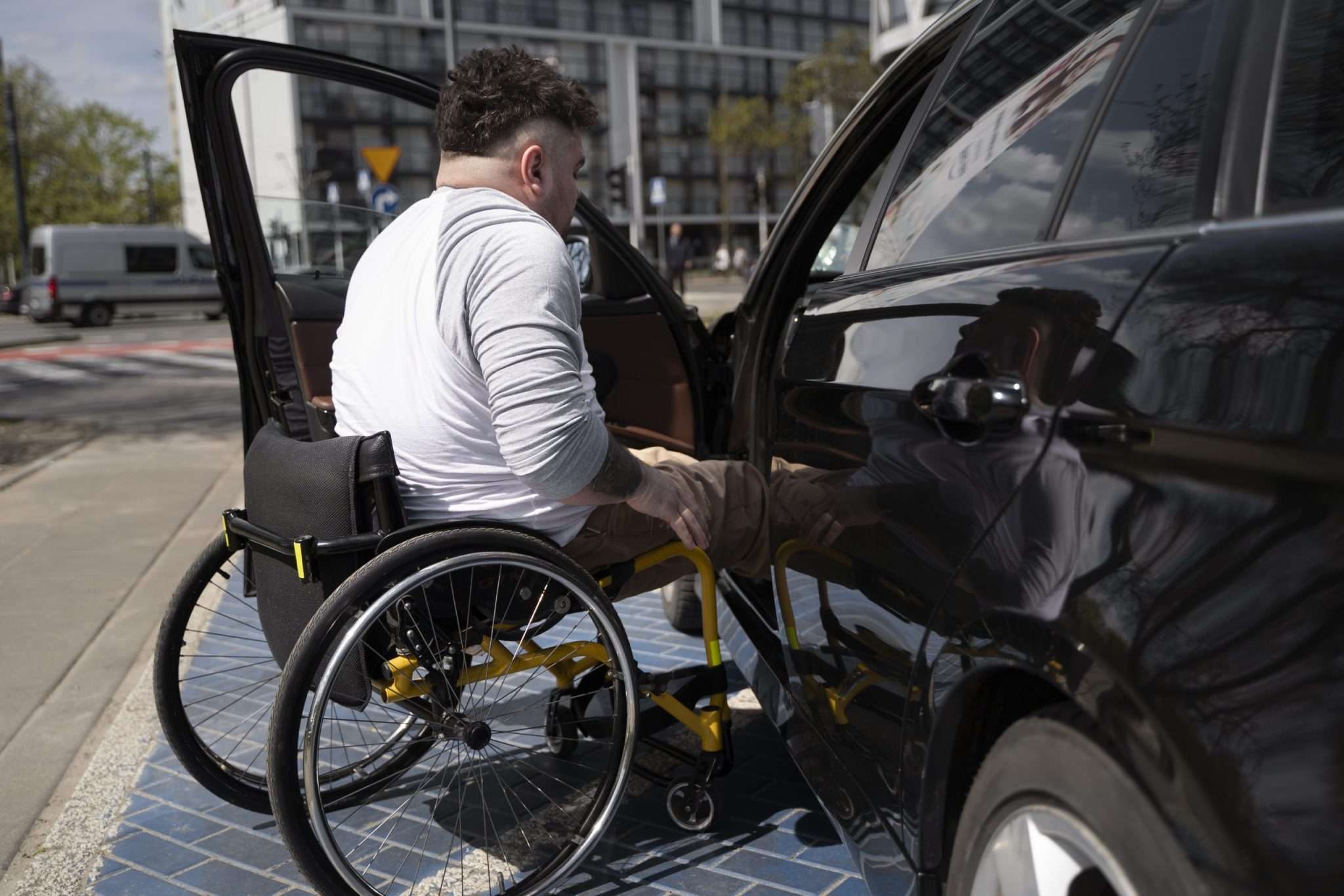 Person in wheelchair entering car at Staten Island car dealerships.